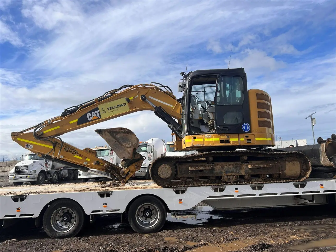 YellowX excavator loaded on a float for delivery